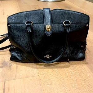 Black medium to large coach bag with a strap attached